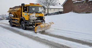 Gritter on snowy road